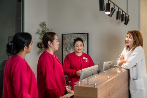 Welcoming reception team assisting a female patient at Najat Hazimeh Clinic, Dubai women’s health center